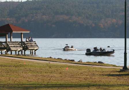 Two boats in the second flight idle past the check-in as staff from the American Bass Association makes sure none of the boats arrive late.