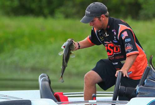 Flurry moves to the back of the boat to place the fish in the livewell.