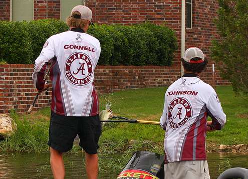 Connell boats a fish with an assist from Johnson.