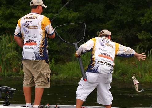 Campisano reaches for a bass caught by Graben.