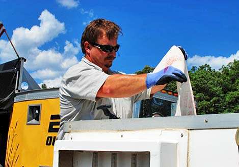 <p>
Colton Dennis from the Arkansas Game and Fish Commission loads the bass into a catch and release boat so that future anglers have the opportunity to catch them again.</p>