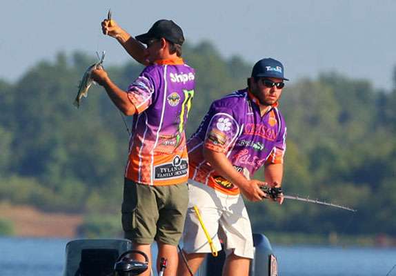 Shipes removes the hooks from the fish, while Horwatt gets back to work.