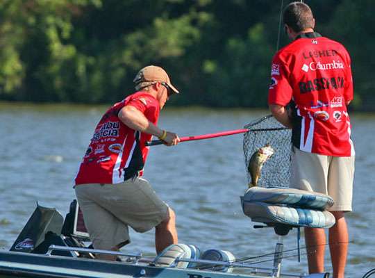 Both teammates do their jobs and the fish is in the boat.