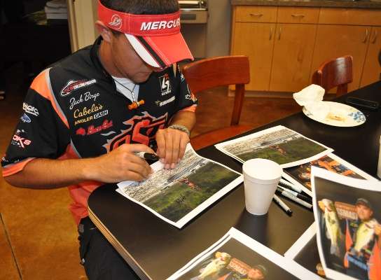 <p>
Zack Birge stayed busy signing photos of himself and Flurry on the water.</p>