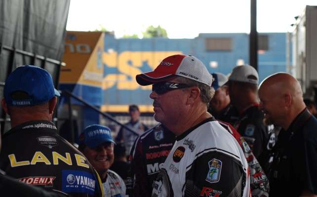 As anglers line up to weigh in, a fast moving train screeches by in the background.