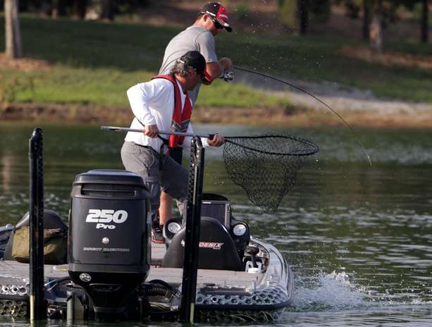 Drew Benton hooks up with a keeper and his co-angler readies the dip net. 