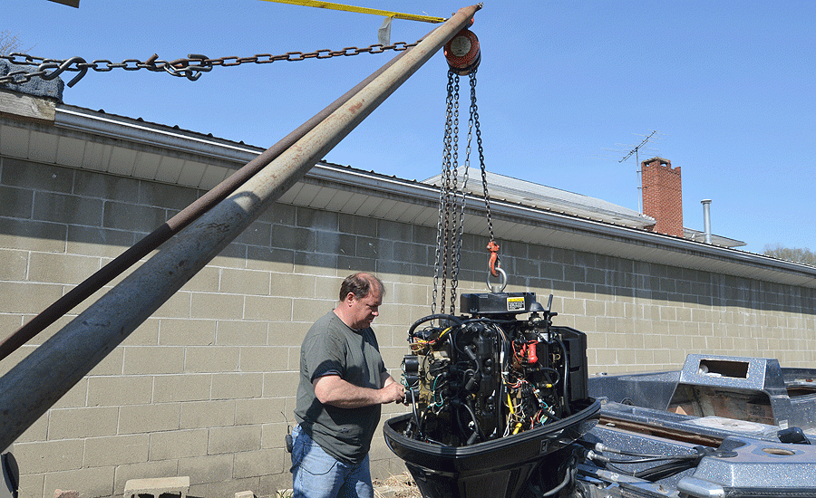 Schwarzel lifted the outboard with the winch to take pressure off the bolts that hold the engine to the transom.