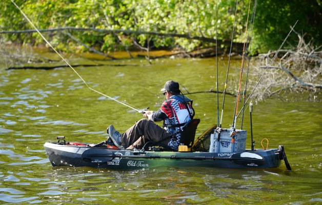 a kayak angler casts