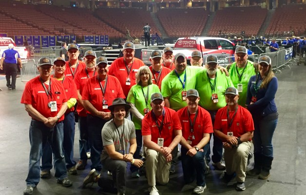 Volunteers pose on the arena floor before the Classic