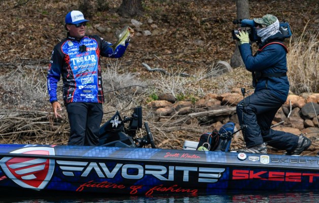 Scott Martin holds up a bass to the LIVE camera